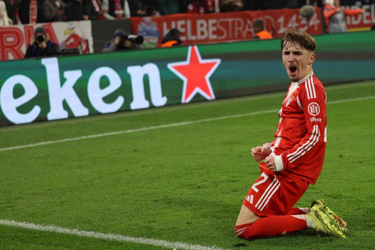 Bayern Munich's German midfielder #42 Lennart Karl celebrates scoring his team's second goal 2:1 during the UEFA Champions League, league phase - day 6 football match between Bayern Munich and Sporting CP in Munich, southern Germany, on December 9, 2025.  Alexandra BEIER / AFP