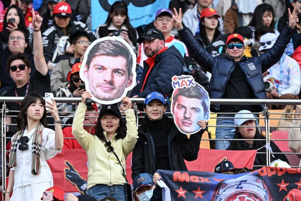 Supporters cheers with cut-outs of Red Bull Racing's Dutch driver Max Verstappen prior to the Formula One Chinese Grand Prix at the Shanghai International Circuit in Shanghai on March 15, 2026.  Greg Baker / AFP