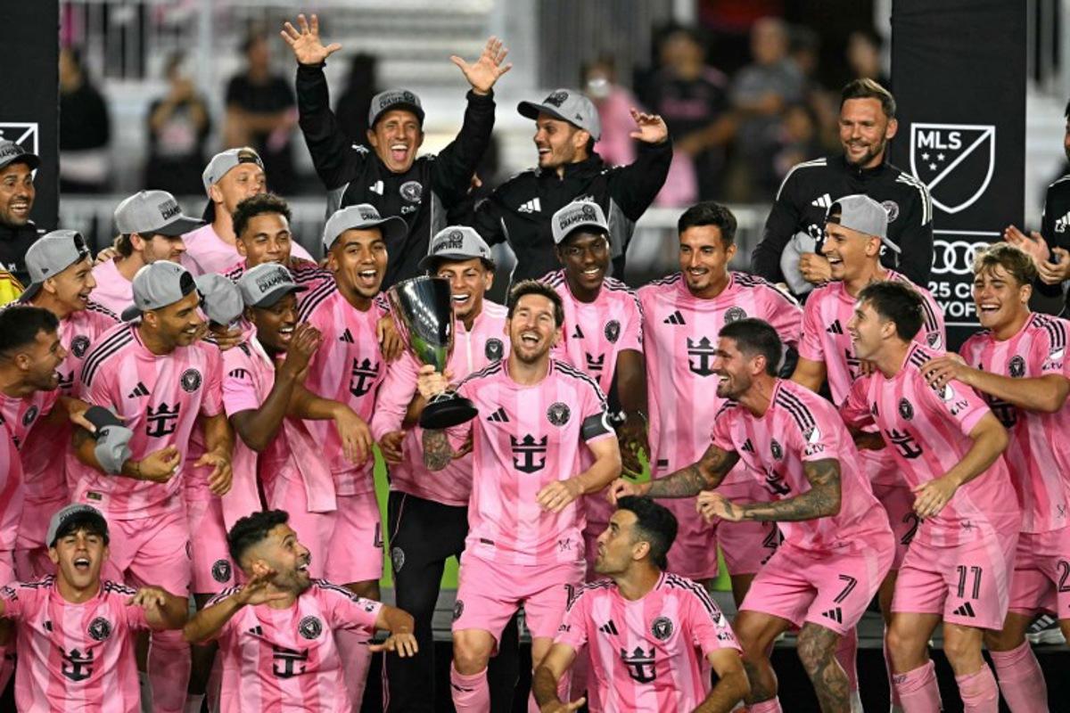 Inter Miami's Argentine forward #10 Lionel Messi (C) celebrates with the trophy after his team's victory in the Major League Soccer (MLS) Eastern Conference final football match between Inter Miami and New York City FC at Chase Stadium in Fort Lauderdale, Florida on November 29, 2025. Lionel Messi and Inter Miami reached the MLS Cup final for the first time on November 29, 2025 after a 5-1 thrashing of New York City FC in the Eastern Conference playoffs. CHANDAN KHANNA / AFP