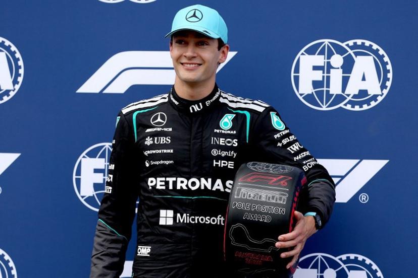 Pole position winner Mercedes' British driver George Russell celebrates on stage after the qualifying session after the qualifying session of the Formula One Australian Grand Prix at the Albert Park Circuit in Melbourne on March 7, 2026.   Martin KEEP / AFP