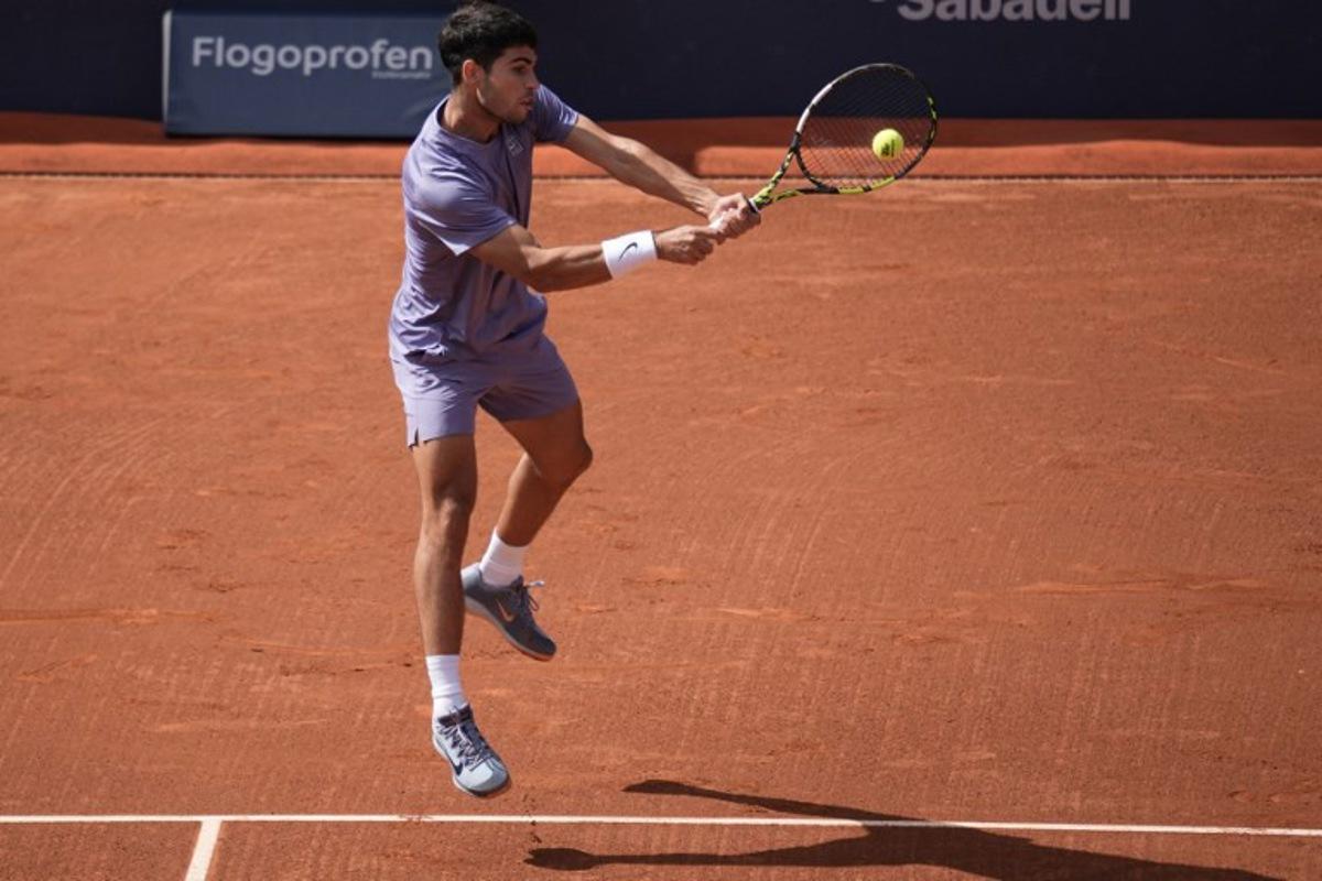 Spain's Carlos Alcaraz returns the ball to France's Arthur Fils during the ATP Barcelona Open "Conde de Godo" tennis tournament singles semi-final match at the Real Club de Tenis in Barcelona, on April 19, 2025.  MANAURE QUINTERO / AFP
