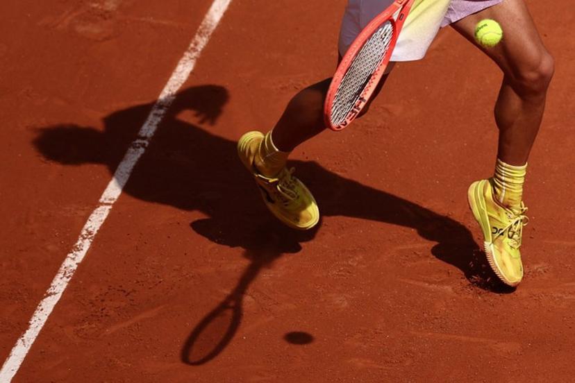 The shadow of Italy's Flavio Cobolli laying a forehand to Germany's Alexander Zverev is casted on the clay during their men's singles match on day 7 of the French Open tennis tournament on Court Philippe-Chatrier at the Roland-Garros Complex in Paris on May 31, 2025.  Anne-Christine POUJOULAT / AFP