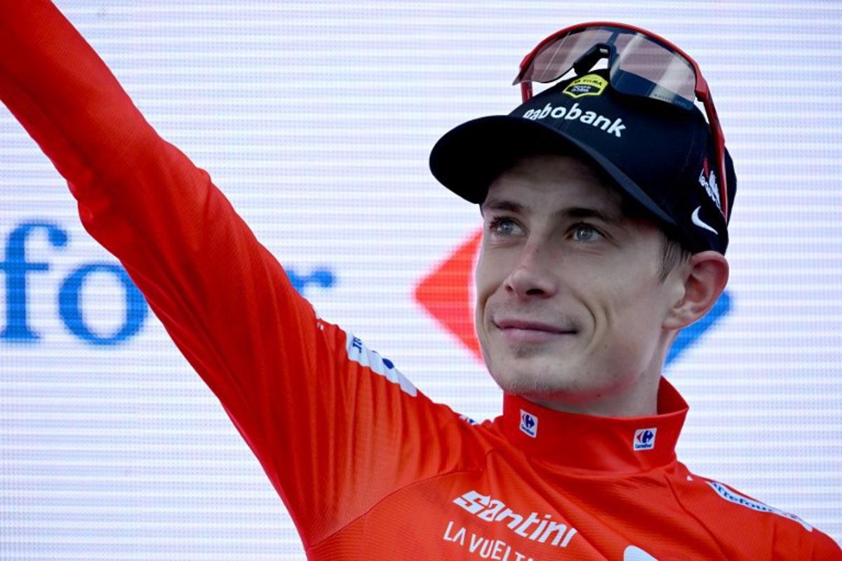 Overall race leader red jersey holder team Visma-Lease a bike's Danish rider Jonas Vingegaard celebrates on the podium of the 19th stage of the Vuelta a Espana, a 159 km race between Rueda and Guijuelo, on September 12, 2025.    Miguel RIOPA / AFP