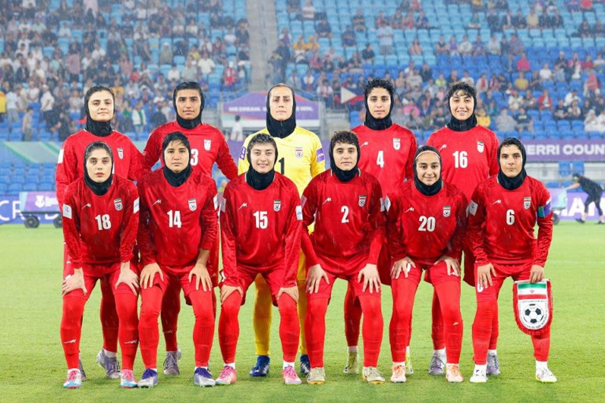 Iran's team pose for a group photo before the AFC Women's Asian Cup Australia 2026 match between Iran and the Philippines in Gold Coast on March 8, 2026. The son of the late shah urged Canberra on March 9 to protect the Iranian women's football team, who were branded "wartime traitors" after refusing to sing the national anthem while playing in Australia.  STR / AFP