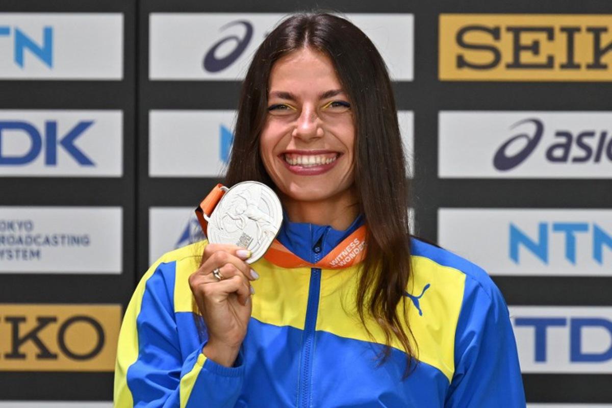 Ukraine's silver medallist Maryna Bekh-Romanchuk celebrates with her medal during the podium ceremony for the Women's Triple Jump during the World Athletics Championships in Budapest on August 26, 2023.  Antonin THUILLIER / AFP