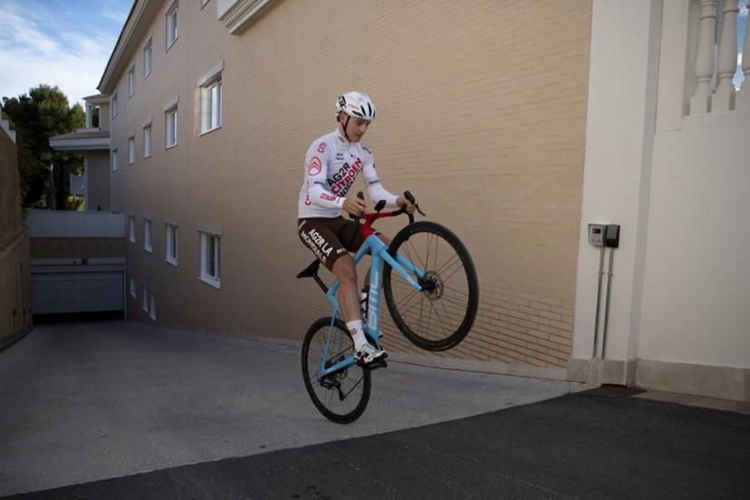 Team AG2R French cyclist Pierre Gautherat does a wheelie prior to taking part in a training session in La Nucia, near Alicante, on January 13, 2023.  JORGE GUERRERO / AFP