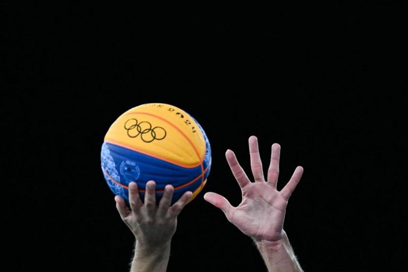 Players try to grab the ball in the men's 3x3 basketball play-in games between Serbia and France during the Paris 2024 Olympic Games at La Concorde in Paris on August 4, 2024.  Luis ROBAYO / AFP