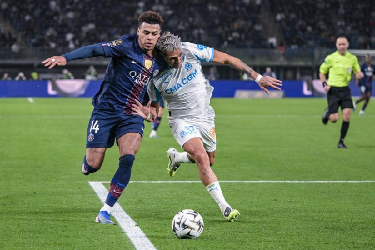Paris Saint-Germain's French midfielder #14 Desire Doue (L) fights for the ball with Marseille's Argentinian defender #32 Facundo Medina during the French Champions' Trophy (Trophee des Champions) football match between Paris Saint-Germain (PSG) and Olympique de Marseille (OM) at the Jaber Al-Ahmad International Stadium in Kuwait City on January 8, 2026.  Yasser AL ZAYYAT / AFP