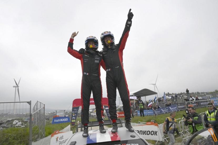 French driver Sebastien Ogier (R) and co-driver Vincent Landais celebrate on top of their Toyota GR Yaris Rally 1 after winning the World Rally Championship (WRC) Rally of Portugal at the end of the SS24 stage in Fafe, on May 18, 2025.  MIGUEL RIOPA / AFP