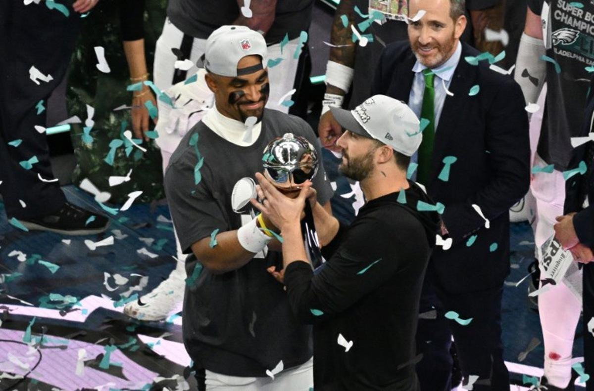 Philadelphia Eagles' quarterback #01 Jalen Hurts and head coach Nick Sirianni hold the Lombardi trophy at the end of Super Bowl LIX, after the Philadelphia Eagles defeated the Kansas City Chiefs 40-22 at Caesars Superdome in New Orleans, Louisiana, February 9, 2025.  Chandan Khanna / AFP