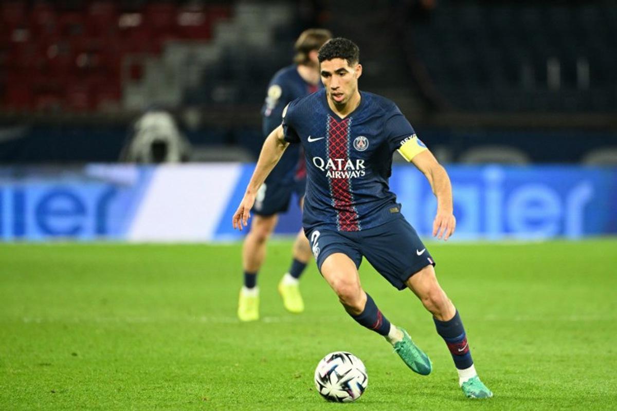 Paris Saint-Germain's Moroccan defender #02 Achraf Hakimi runs with the ball during the French L1 football match between Paris Saint-Germain (PSG) and FC Metz at the Parc des Princes stadium in Paris on February 21, 2026.  Bertrand GUAY / AFP