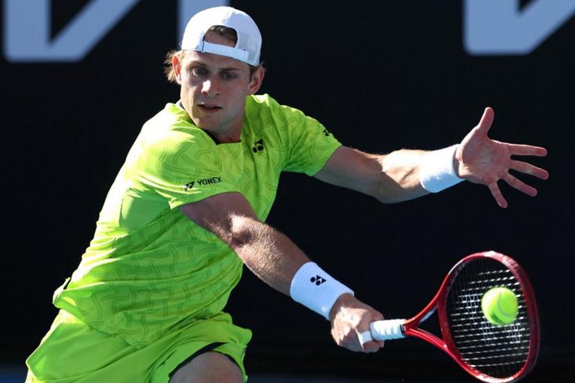 Belgium's Zizou Bergs hits a return to Poland's Hubert Hurkacz during their men's singles match on day three of the Australian Open tennis tournament in Melbourne on January 20, 2026.  IZHAR KHAN / AFP