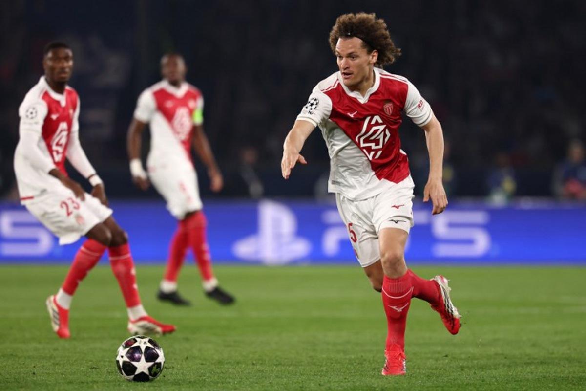 Monaco's Belgian defender #25 Wout Faes (R) gestures as he runs with the ball during the UEFA Champions League play-off second leg football match between Paris Saint-Germain (PSG) and AS Monaco at the Parc des Princes stadium in Paris on February 25, 2026.  FRANCK FIFE / AFP