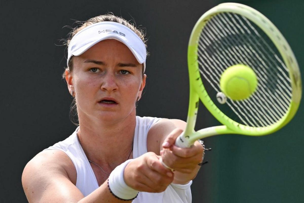 Czech Republic's Barbora Krejcikova plays a backhand return to US player Caroline Dolehide during their women's singles second round tennis match on the fourth day of the 2025 Wimbledon Championships at The All England Lawn Tennis and Croquet Club in Wimbledon, southwest London, on July 3, 2025.  Glyn KIRK / AFP