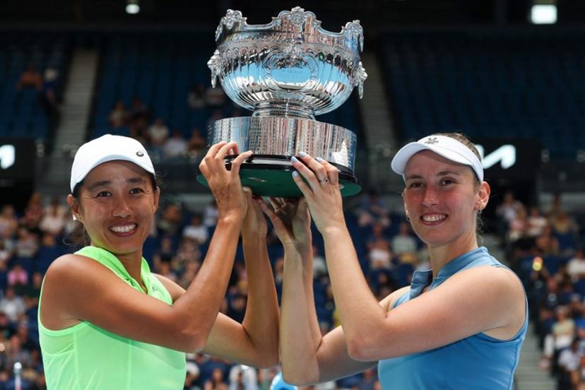 China's Zhang Shuai (L) and partner Belgium's Elise Mertens pose with the winners' trophy after their victory in their women's doubles final match against Kazakhstan's Anna Danilina and Serbia's Aleksandra Krunic on day fourteen of the Australian Open tennis tournament in Melbourne on January 31, 2026.  DAVID GRAY / AFP