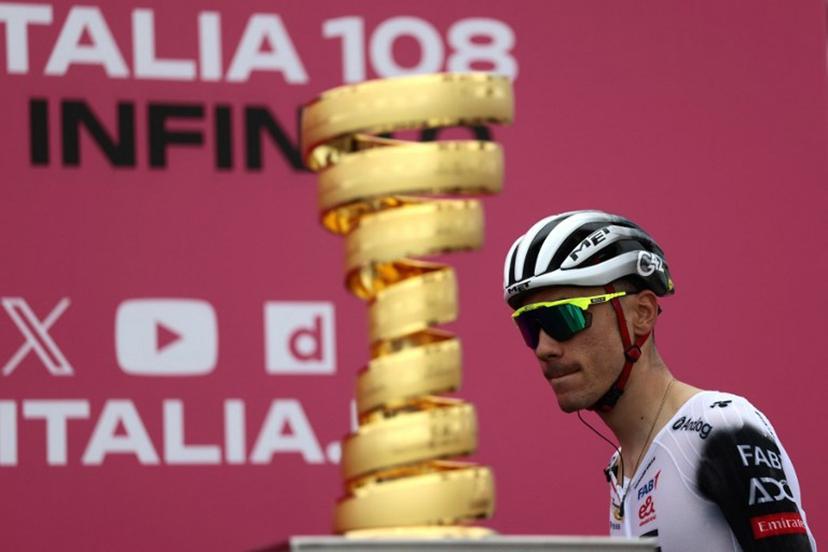 UAE Team Emirates XRG's Spanish rider Juan Ayuso walks past the Giro d'Italia trophy ("trofeo senza fine") prior to the first stage of the 108th Giro d'Italia cycling race, 160km from Durres to Tirana in Albania, on May 9, 2025.  Luca Bettini / AFP