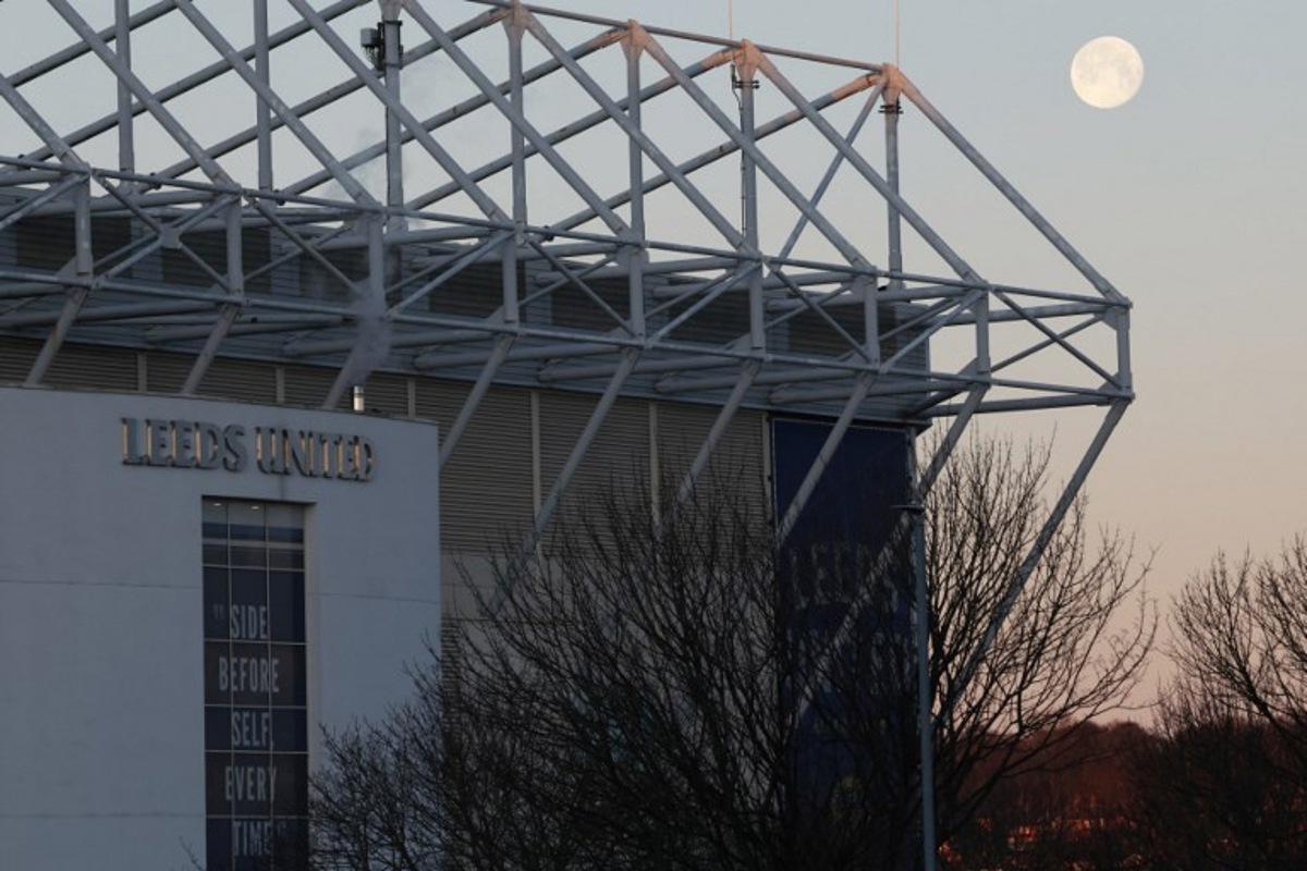 The moon sets and the sun rises at Elland Road in Leeds, northern England on January 4, 2026 ahead of the English Premier League football match between Leeds United and Manchester United.  Darren Staples / AFP