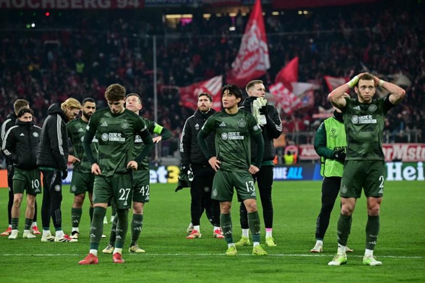 Celtic players reacts after the UEFA Champions League second-leg, knockout phase play-off match FC Bayern Munich vs Celtic on February 18, 2025 in Munich.  Tobias SCHWARZ / AFP