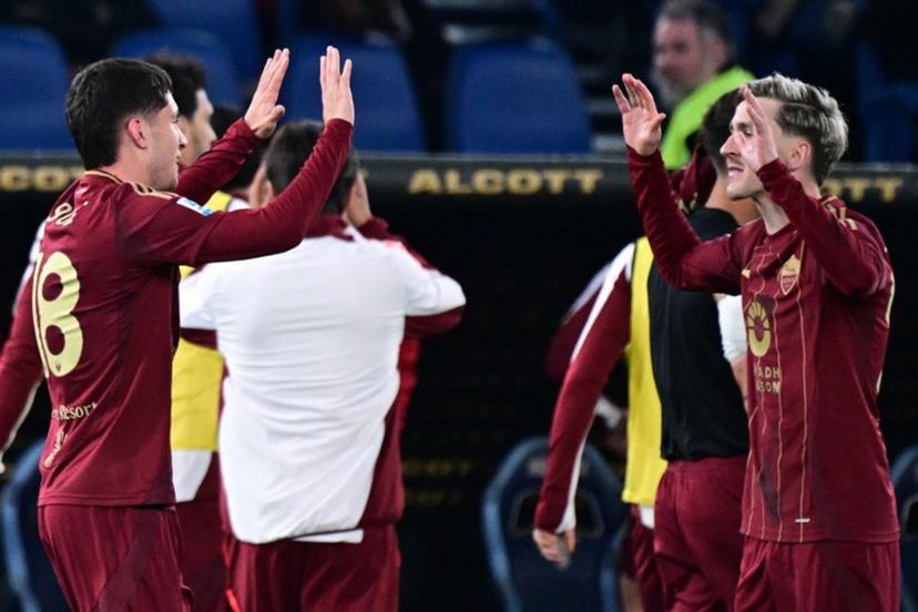 Roma's Argentine forward #18 Matias Soule celebrates with teammate Roma's Belgian forward #56 Alexis Saelemaekers (R) after scoring his team's first goal during the Italian Serie A football match between Lazio and Roma at the Olympic Stadium in Rome on April 13, 2025.  Tiziana FABI / AFP