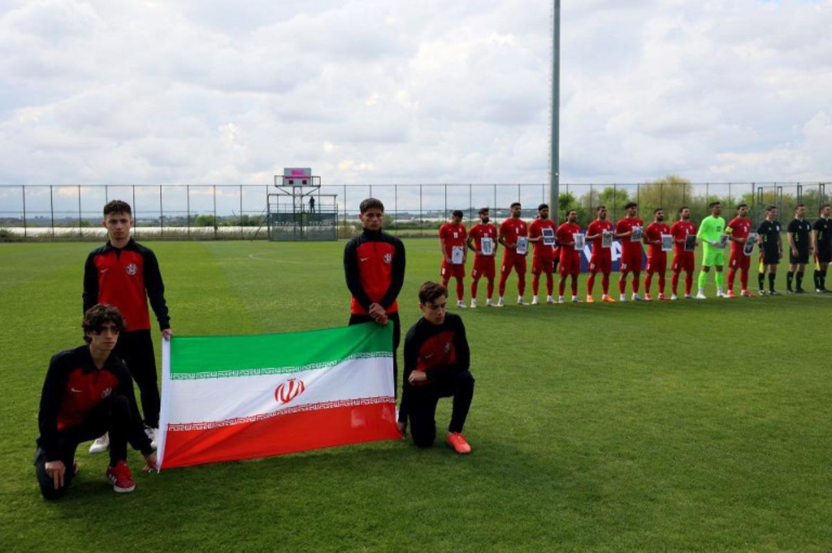 Iran's national team players pose for photographers holding pictures of children allegedly killed in a U.S. strikes in Iran, prior a friendly football match between Iran and Costa Rica, in Antalya, southern Turkey, on March 31, 2026. FIFA president Gianni Infantino told AFP Tuesday that Iran "will be at the World Cup" despite the Middle East war Adem ALTAN / AFP