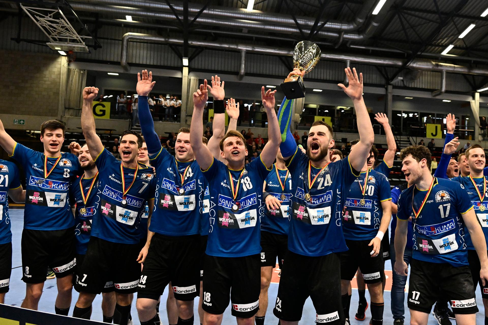 Bocholt's Serge Spooren, Bocholt's Thomas Driesen and Bocholt's Tim Claessens celebrate after winning a game between Achilles Bocholt and Sporting Pelt, the men's final of the Belgian handball cup, Saturday 01 April 2023, in Hasselt. BELGA PHOTO JOHAN EYCKENS