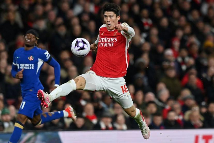 Arsenal's Japanese defender #18 Takehiro Tomiyasu controls the ball during the English Premier League football match between Arsenal and Chelsea at the Emirates Stadium in London on April 23, 2024.   Glyn KIRK / AFP