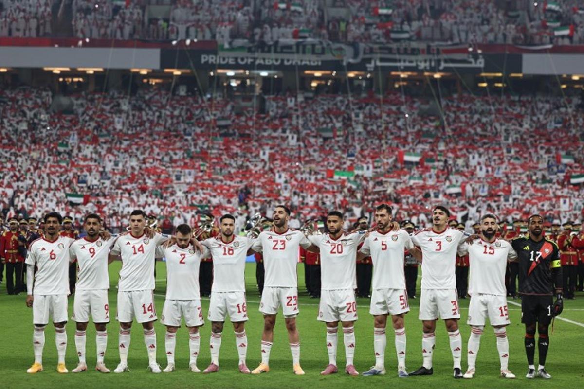 UAE players stand for their national anthem ahead of the FIFA World Cup 2026 Asian qualifier football match between the United Arab Emirates and Iraq at the Mohammed bin Zayed Stadium in Abu Dhabi on November 13, 2025.  Fadel SENNA / AFP