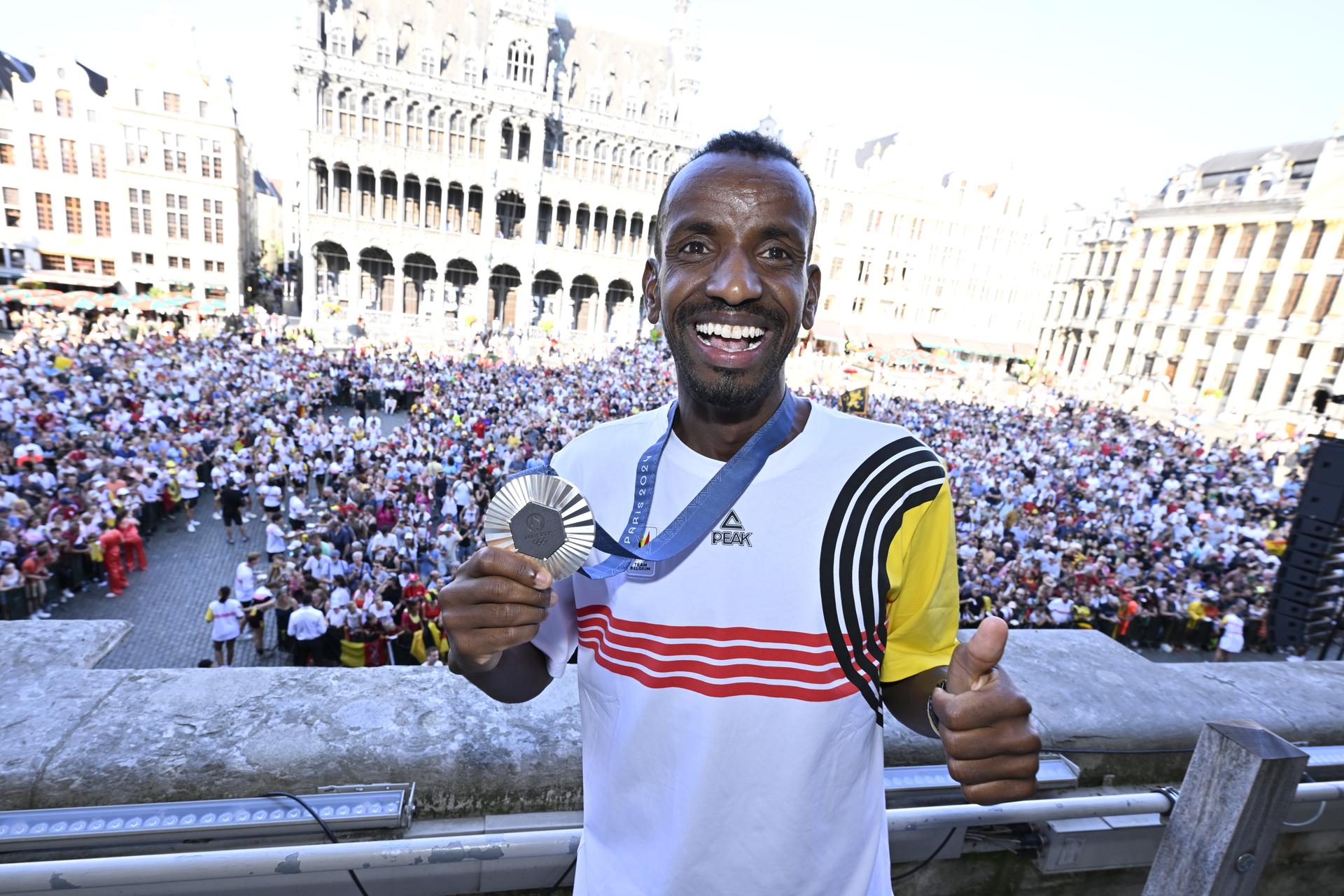 Belgian athlete Bashir Abdi poses with his silver medal during celebrations after the Paris 2024 Olympic Games, at the Grand Place - Grote Markt and the Brussels City Hall, in Brussels, on Monday 12 August 2024. The Belgian delegation at the Games of the XXXIII Olympiad counted 165 athletes competing in 21 sports. BELGA PHOTO ERIC LALMAND