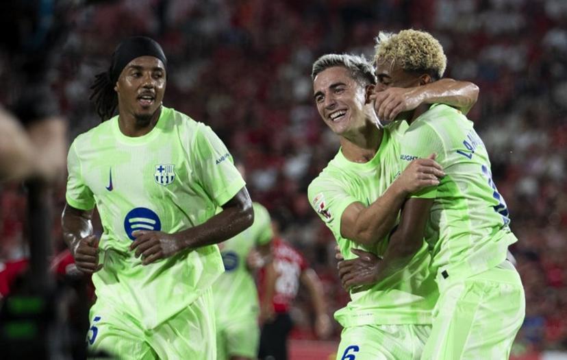 Barcelona's Spanish forward #10 Lamine Yamal (R) celebrates scoring his team's third goal with Barcelona's Spanish midfielder #06 Pablo Gavi during the Spanish league football match between RCD Mallorca and FC Barcelona at Mallorca Son Moix Stadium in Palma de Mallorca on August 16, 2025.  JAIME REINA / AFP
