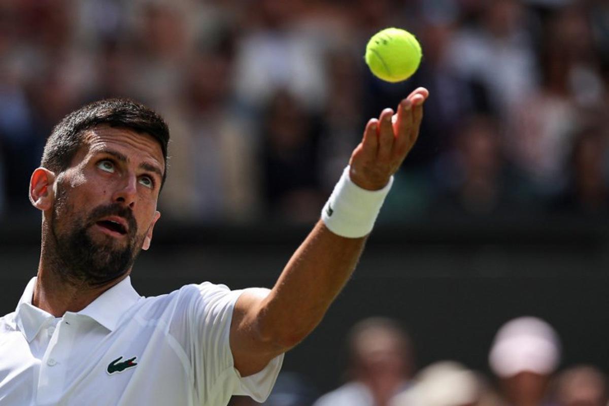 Serbia's Novak Djokovic serves to Britain's Daniel Evans during their men's singles second round tennis match on the fourth day of the 2025 Wimbledon Championships at The All England Lawn Tennis and Croquet Club in Wimbledon, southwest London, on July 3, 2025.  Adrian Dennis / AFP