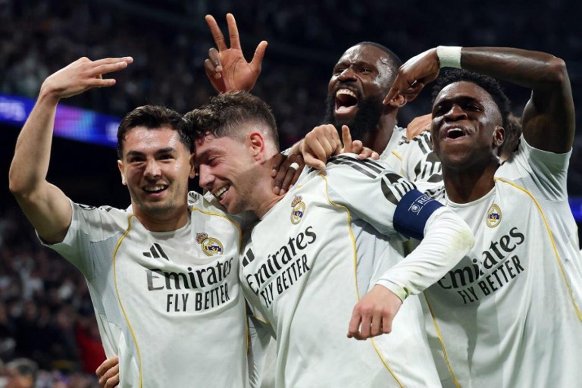 Real Madrid's Uruguayan midfielder #08 Federico Valverde (2L) celebrates his third goal during the UEFA Champions League last 16 first leg football match between Real Madrid CF and Manchester City at Santiago Bernabeu Stadium in Madrid on March 11, 2026.  Pierre-Philippe MARCOU / AFP