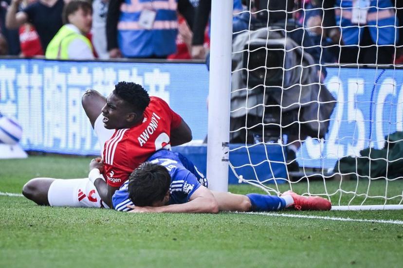 Nottingham Forest's Nigerian striker #09 Taiwo Awoniyi (L) and Leicester City's Argentinian midfielder #40 Facundo Buonanotte (R) react after colliding during the English Premier League football match between Nottingham Forest and Leicester City at The City Ground in Nottingham, central England, on May 11, 2025.  JUSTIN TALLIS / AFP