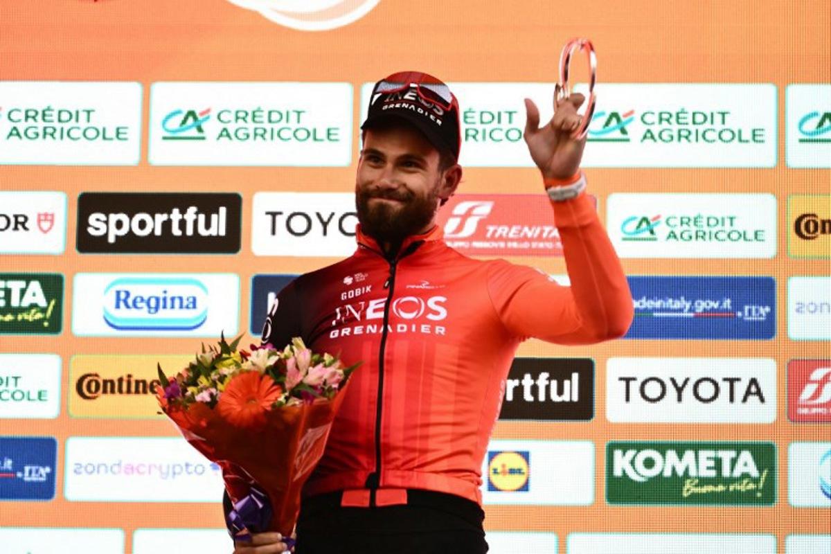 Ineos' Italian rider Filippo Ganna, second, celebrates during the podium ceremony of the Milan - Sanremo one-day classic cycling race, on March 22, 2025. Dutch Mathieu Van Der Poel of team Alpecin-Deceuninck won the race ahead of Team Ineos' Italian rider Filippo Ganna and Team UAE's Slovenian rider Tadej Pogacar, third.  Marco BERTORELLO / AFP