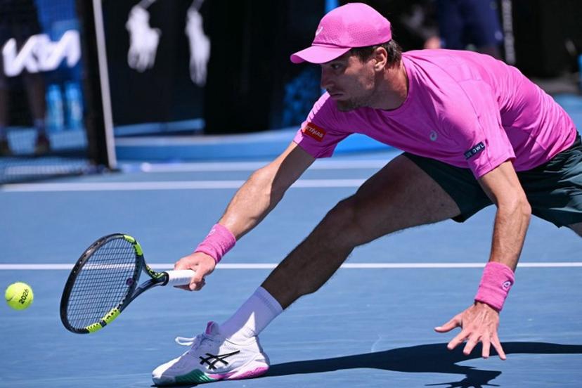 Belgium's Raphael Collignon hits a return against Italy's Lorenzo Musetti during their men's singles match on day three of the Australian Open tennis tournament in Melbourne on January 20, 2026.  WILLIAM WEST / AFP