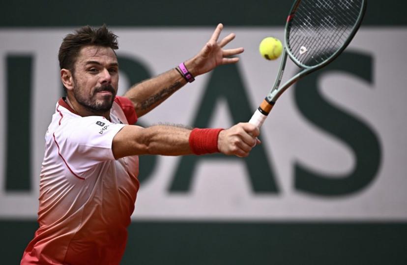 Switzerland's Stan Wawrinka plays a backhand return to Great Britain's Jacob Fearnley during their men's singles match on day 2 of the French Open tennis tournament at the Roland-Garros Complex in Paris on May 26, 2025.  JULIEN DE ROSA / AFP