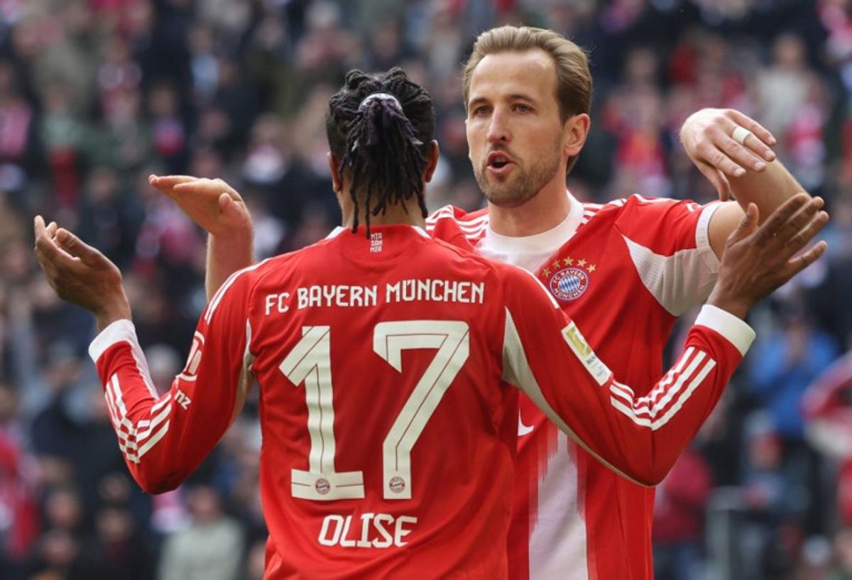 Bayern Munich's French midfielder #17 Michael Olise celebrates his 1-0 with Bayern Munich's English forward #09 Harry Kane during the German first division Bundesliga football match between FC Bayern Munich and Union Berlin in Munich, southern Germany, on March 21, 2026.  Karl-Josef HILDENBRAND / AFP