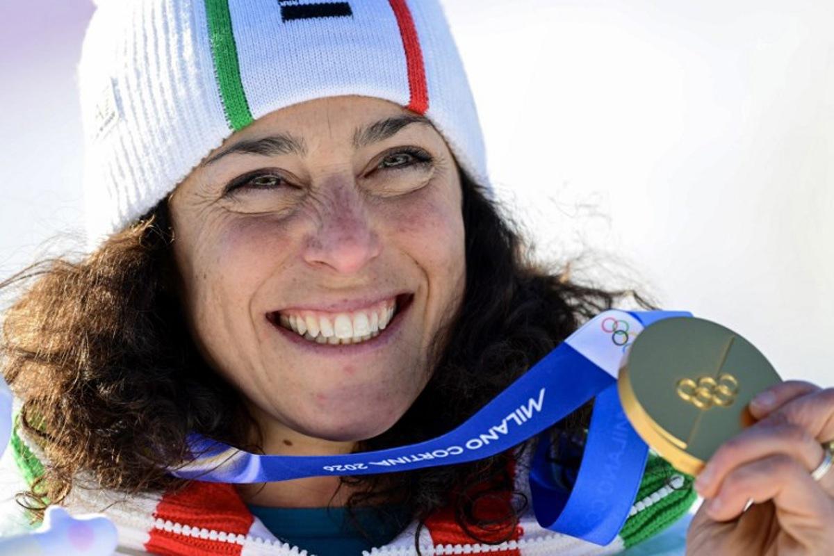 Gold medallist Italy's Federica Brignone poses on the podium of the women's giant slalom event during the Milano Cortina 2026 Winter Olympic Games at the Tofane Alpine Skiing Centre in Cortina d'Ampezzo on February 15, 2026.  Stefano RELLANDINI / AFP