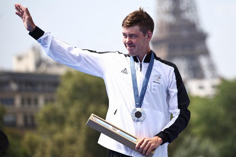 Silver medallist New Zealand's Hayden Wilde gestures on the podium during the victory ceremony for the men's individual triathlon at the Paris 2024 Olympic Games in central Paris on July 31, 2024.  Anne-Christine POUJOULAT / AFP