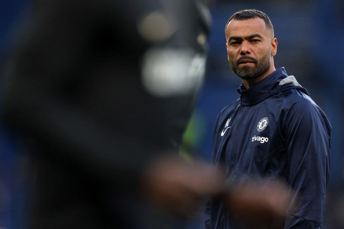 Chelsea assistant coach Ashley Cole watches players warm up ahead of the Champions League quarter-final second-leg football match between Chelsea and Real Madrid at Stamford Bridge in London on April 18, 2023.  Adrian DENNIS / AFP