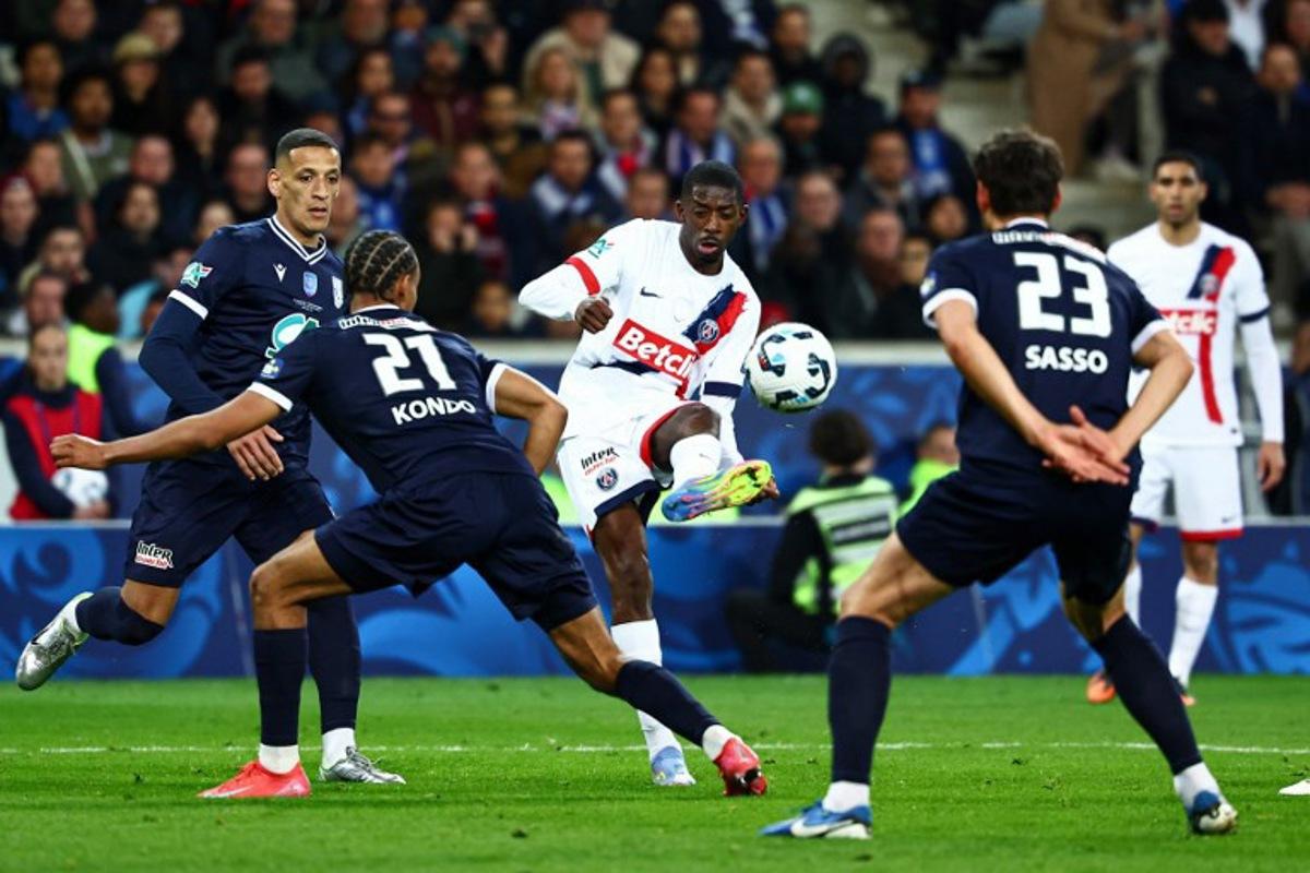 Paris Saint-Germain's French forward #10 Ousmane Dembele (C) kicks the ball during the French Cup (Coupe de France) semi-final football match between USL Dunkirk and Paris Saint-Germain (PSG) at the Pierre-Mauroy stadium in Villeneuve-d'Ascq, northern France, on April 1, 2025.  Sameer Al-Doumy / AFP