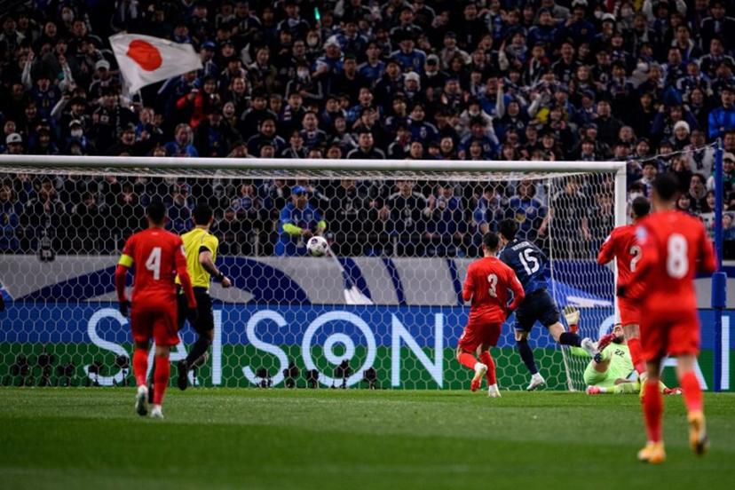 Japan's Daichi Kamada (#15) scores the goal during the 2026 FIFA World Cup Asian qualification football match between Japan and Bahrain in Saitama on March 20, 2025.  Philip FONG / AFP
