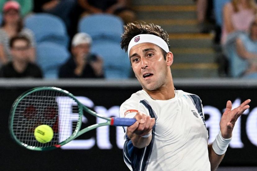 Argentina's Tomas Martin Etcheverry hits a return to Kazakhstan's Alexander Bublik during their men's singles match on day six of the Australian Open tennis tournament in Melbourne on January 23, 2026.  Paul Crock / AFP