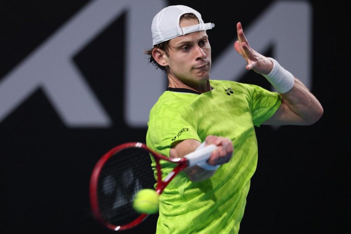 Belgium's Zizou Bergs hits a shot against Poland's Hubert Hurkacz during their men's singles match on day three of the Australian Open tennis tournament in Melbourne on January 20, 2026.  IZHAR KHAN / AFP