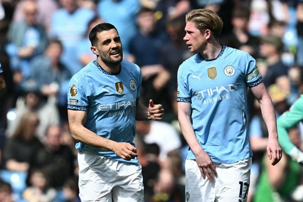 Manchester City's Croatian midfielder #08 Mateo Kovacic (L) celebrates with Manchester City's Belgian midfielder #17 Kevin De Bruyne (R) after scoring their third goal during the English Premier League football match between Manchester City and Crystal Palace at the Etihad Stadium in Manchester, north west England, on April 12, 2025. Paul ELLIS / AFP