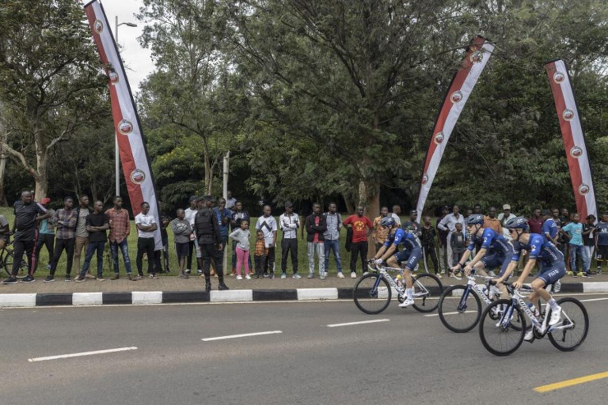 Residents gather to look at team Equipe continentale Groupama-FDJ team before the beginning of the final stage of the 16h Tour du Rwanda on 25 February 2024, in Kigali. Israel Premier Tech's British rider Joseph Blackmore, won the Tour of Rwanda which ended on Sunday in the capital Kigali.  Guillem Sartorio / AFP