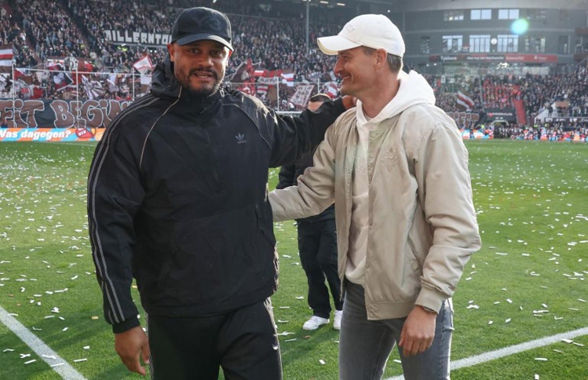 Bayern Munich's Belgian head coach Vincent Kompany (L) and St Pauli's German head coach Alexander Blessin greet each other prior to the German first division Bundesliga football match between FC St Pauli and FC Bayern Munich in Hamburg, northern Germany, on April 11, 2026.  Ibo OT / AFP