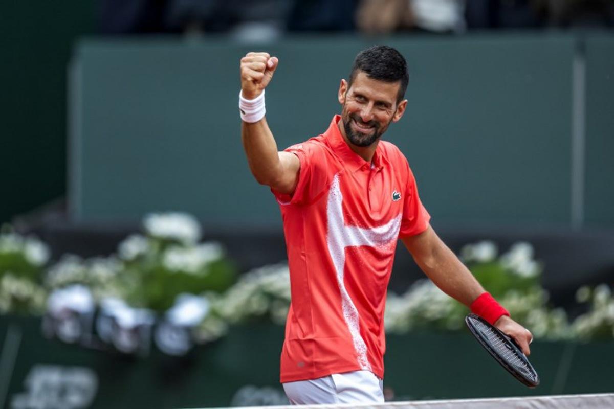 Serbia's Novak Djokovic celebrates his victory at the end of his match against Hungary's Marton Fucsovics at the ATP 250 Geneva Open tennis tournament in Geneva on May 21, 2025.   FABRICE COFFRINI / AFP