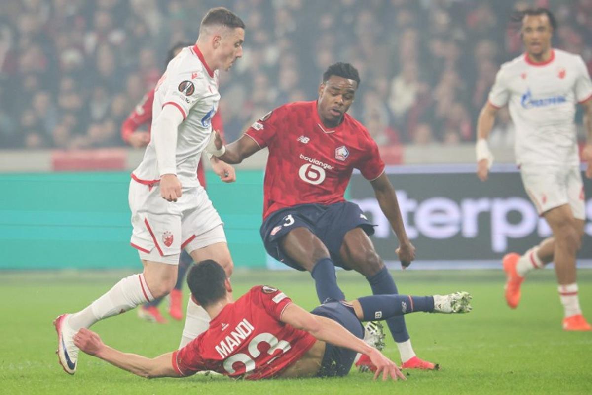 Crvena Zvezda Beograd's Brazilian forward #17 Bruno (L) fights for the ball with Lille's Algerian defender #23 Aissa Mandi 52nd L) and Lille's Belgian defender #03 Nathan Ngoy (C) during the UEFA Europa League - knockout round play-off first leg - football match between LOSC Lille and FK Crvena Zvezda Beograd (Red Star Belgrade) at the Pierre Mauroy Stadium in Villeneuve d'Ascq, northern France, on February 19, 2026.  Francois LO PRESTI / AFP