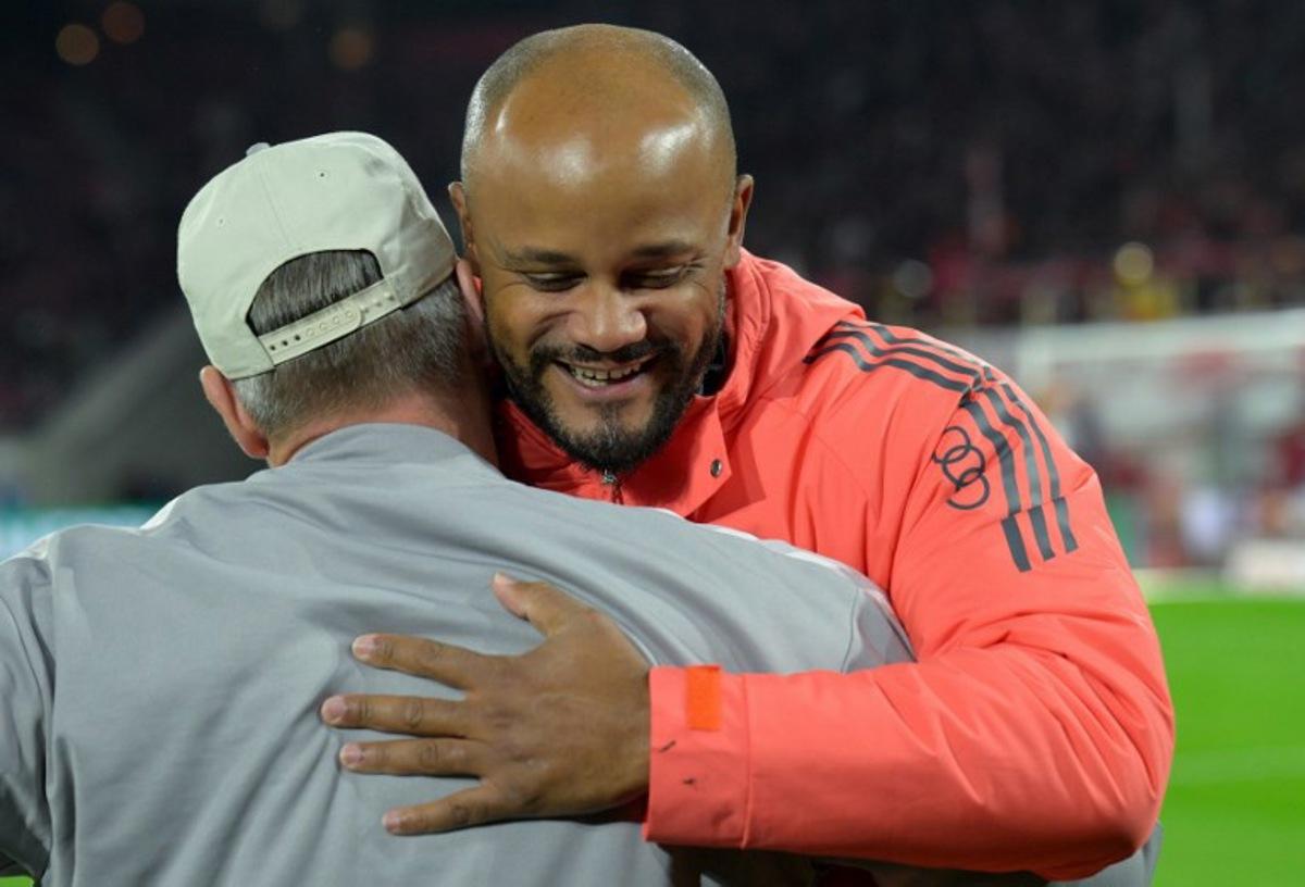 Bayern Munich's Belgian head coach Vincent Kompany embraces FC Cologne's German head coach Lukas Kwasniok prior to the German Cup (DFB Pokal) second round football match between 1 FC Cologne and FC Bayern Munich in Cologne, western Germany on October 29, 2025.  Sascha Schuermann / AFP