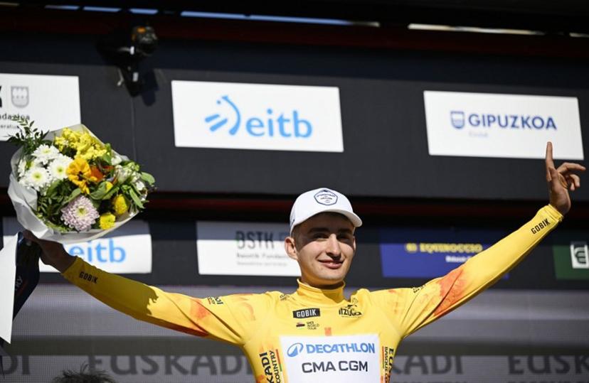 Stage winner Team Decathlon CMA CGM's French rider Paul Seixas stands on the podium wearing the Overall Ranking Leader's yellow jersey after the first stage of the Basque Country's Itzulia cycling tour, a 13.8 km time trial in Bilbao on April 6, 2026.   ANDER GILLENEA / AFP